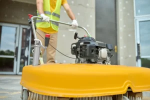 workman applying road sweeper construction site, Post-Construction Cleaning in Miami